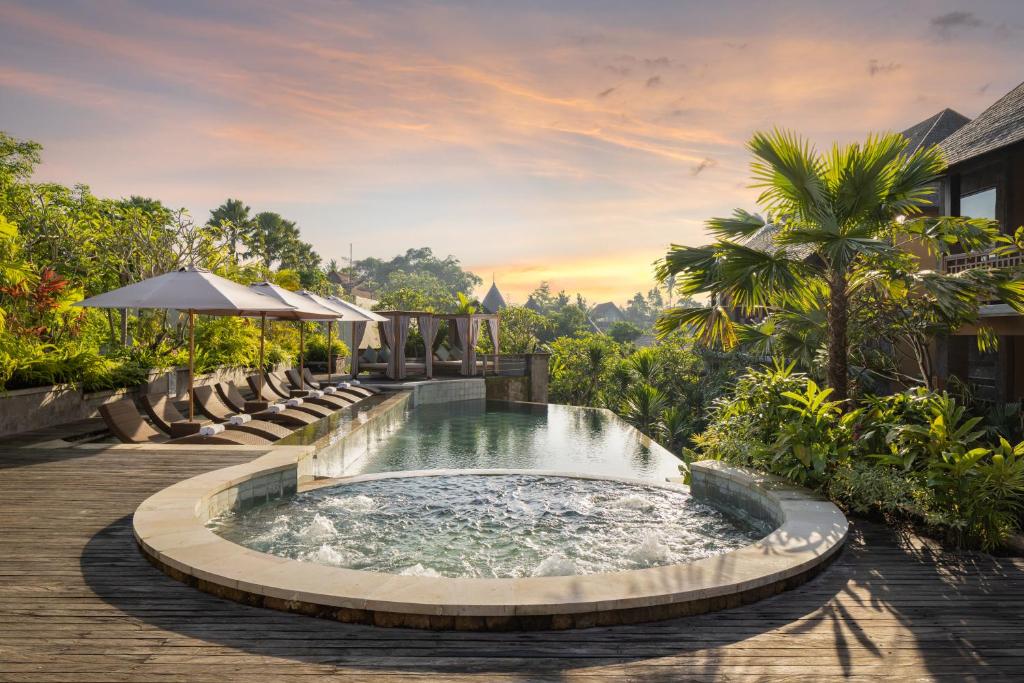 Resort infinity pool terrace with cabana loungers at sunset — ALMAS Hospitality luxury development advisory