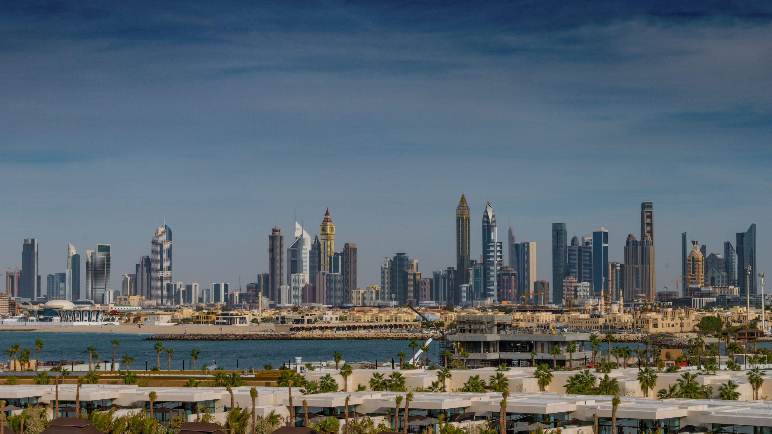 Palm Jumeirah waterfront residences with Dubai skyline in the distance — ALMAS Hospitality luxury development advisory