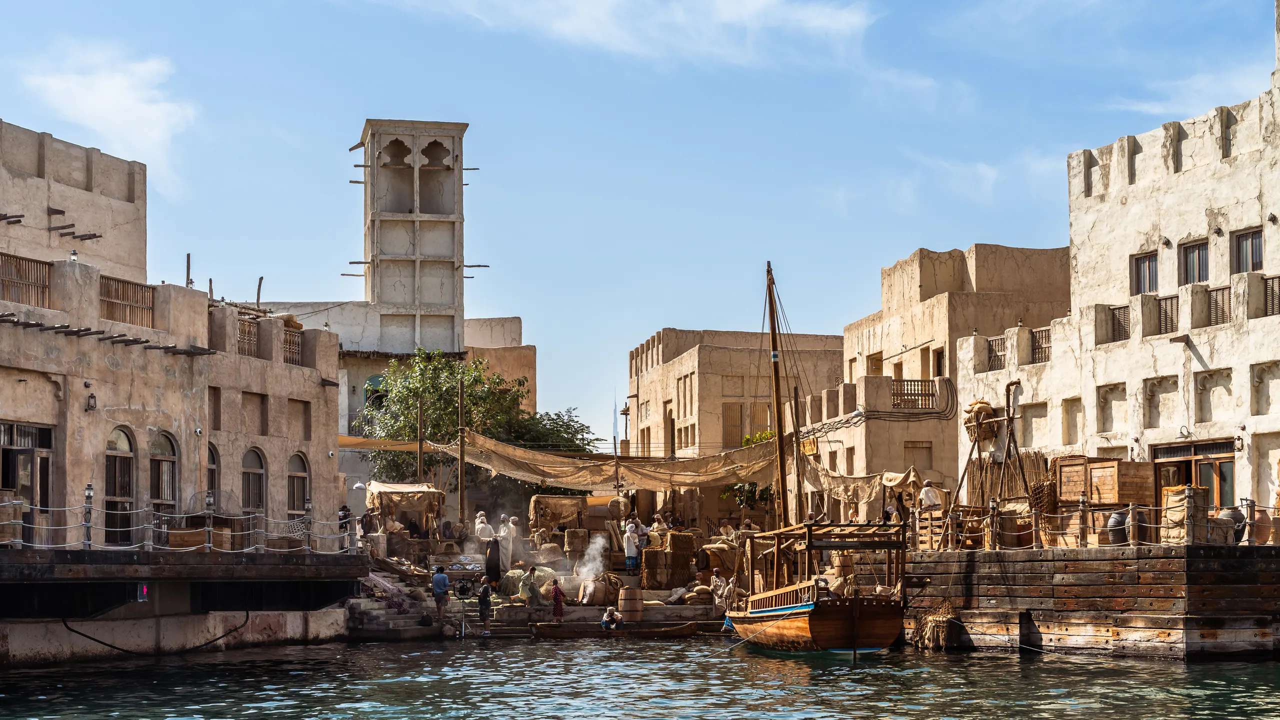 Adaptive reuse hotels in the Gulf: restored heritage buildings in Dubai's Al Fahidi district against a modern skyline